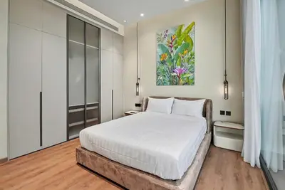 a bedroom with a bed and a painting on the wall at C32 Clover Residence Villa Phuket 3 bd in Ban Thalat Choeng Thale