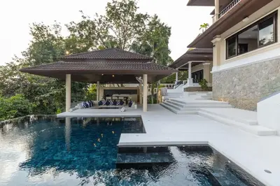 a house with a swimming pool next to a building at 6-Bedroom Private Luxury Pool Villa in Layan in Thalang