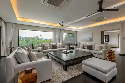 a living room with couches and a coffee table at 6-Bedroom Private Luxury Pool Villa in Layan in Thalang