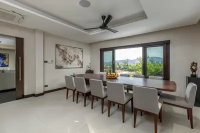 a dining room with a table and chairs at 6-Bedroom Private Luxury Pool Villa in Layan in Thalang