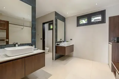 a bathroom with a tub and a sink and a mirror at 6-Bedroom Private Luxury Pool Villa in Layan in Thalang