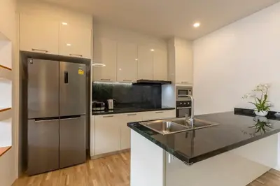 a kitchen with a stainless steel refrigerator and a sink at Modern and Peaceful 3Bedroom Villa Family Retreat Rawai in Ban Saiyuan (1)