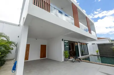 a white house with a swimming pool and a staircase at Modern and Peaceful 3Bedroom Villa Family Retreat Rawai in Ban Saiyuan (1)