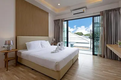 a bedroom with a bed and a large window at Modern and Peaceful 3Bedroom Villa Family Retreat Rawai in Ban Saiyuan (1)