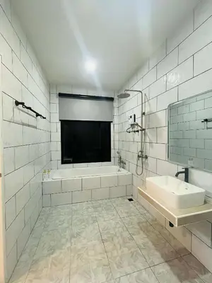 a white bathroom with a tub and a sink at Believe Resort At Koh Yao Yai in Ban Hin Kong