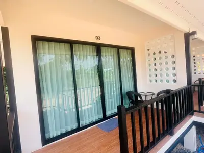 a balcony with sliding glass doors in a house at Believe Resort At Koh Yao Yai in Ban Hin Kong