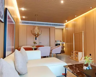 a living room with a white couch and chairs at BB Luxury Villa in Phuket Town
