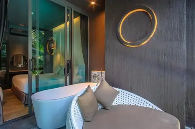 a room with a bath tub and a bedroom at Saturdays Residence by Sure in Ban Saiyuan (1)