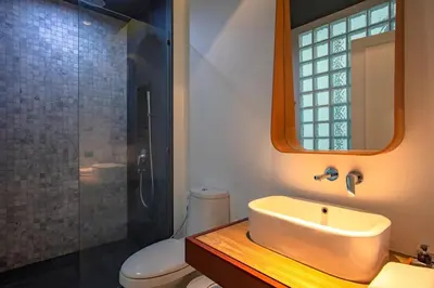 a bathroom with a sink and a shower and a toilet at Saturdays Residence by Sure in Ban Saiyuan (1)