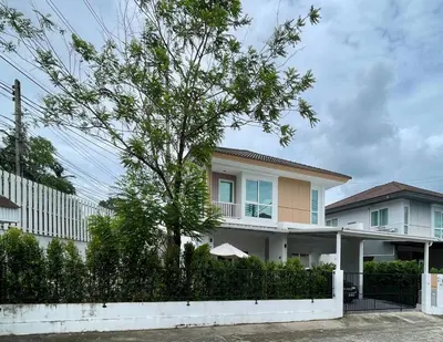 a house with a tree in front of a fence at Spacious Modern Home & Garden Perfect for Families in Ban Na Nai