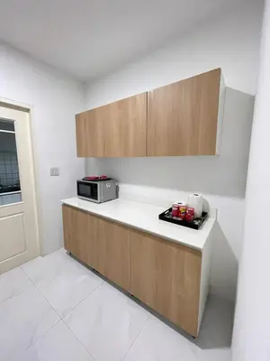 a kitchen with a counter top with a microwave at Spacious Modern Home & Garden Perfect for Families in Ban Na Nai