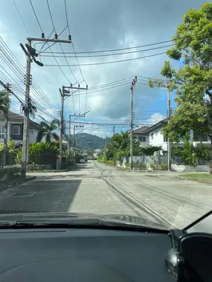 a view from a car of an empty street at Spacious Modern Home & Garden Perfect for Families in Ban Na Nai