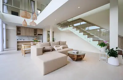 a living room with a couch and a staircase at New Cozy 3BR Pool Villa Best Location- Boat Avenue in Ban Thalat Choeng Thale