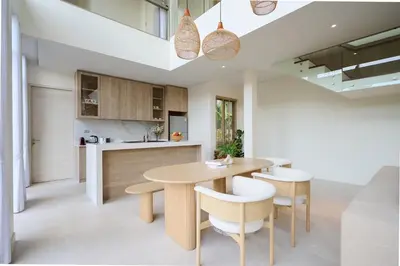 a kitchen and dining room with a wooden table and chairs at New Cozy 3BR Pool Villa Best Location- Boat Avenue in Ban Thalat Choeng Thale
