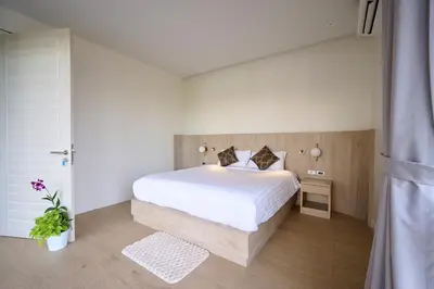 a bedroom with a large white bed in a room at New Cozy 3BR Pool Villa Best Location- Boat Avenue in Ban Thalat Choeng Thale