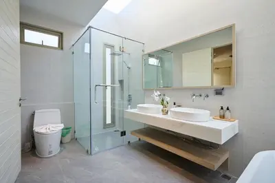 a bathroom with two sinks and a glass shower at New Cozy 3BR Pool Villa Best Location- Boat Avenue in Ban Thalat Choeng Thale