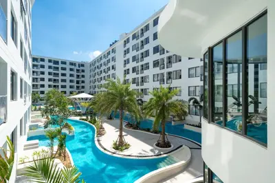 an apartment with a swimming pool in a building at Capri Residence Bangtao in Ban Thalat Choeng Thale
