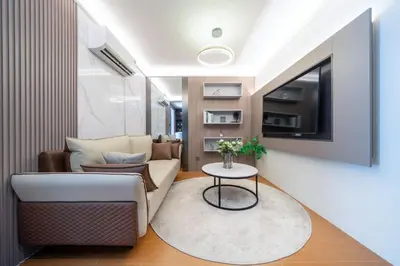 a living room with a couch and a table at Capri Residence Bangtao in Ban Thalat Choeng Thale