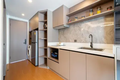 a kitchen with a sink and a refrigerator at Capri Residence Bangtao in Ban Thalat Choeng Thale