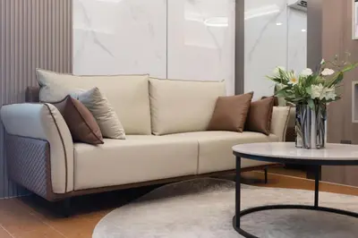 a living room with a couch and a table at Capri Residence Bangtao in Ban Thalat Choeng Thale