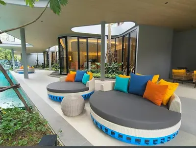 a living room with two couches and a pool at D Condo Reef Kathu,Near Patong beach in Kathu