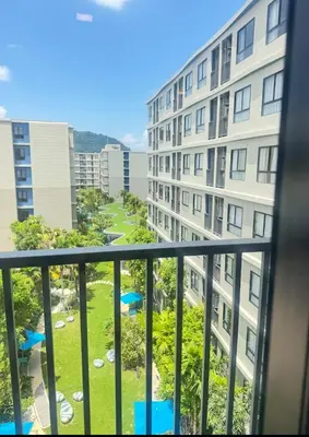 a balcony with a view of a park and buildings at D Condo Reef Kathu,Near Patong beach in Kathu