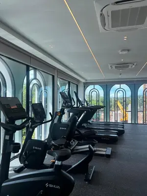 a gym with a row of treadms and elliptical machines at The Title Legendary Bang-Tao Garden Harmony I-406 in Bang Tao Beach