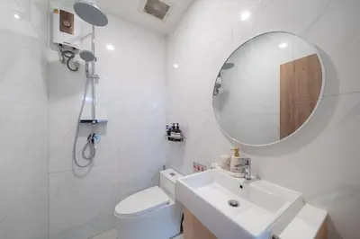 a white bathroom with a sink and a mirror at Heart Patong pool villa with 5bedrooms in Patong Beach