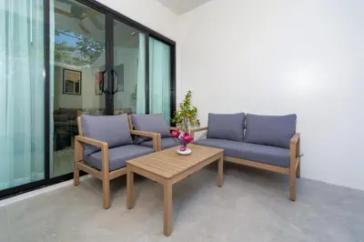 two chairs and a coffee table on a patio at Heart Patong pool villa with 5bedrooms in Patong Beach