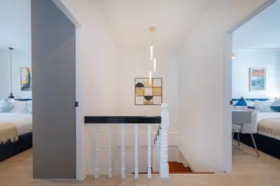 a white room with a bed and a staircase at Heart Patong pool villa with 5bedrooms in Patong Beach