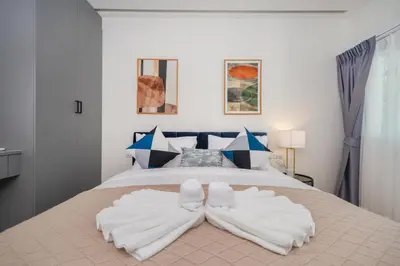 a bedroom with a large bed with two white pillows at Heart Patong pool villa with 5bedrooms in Patong Beach
