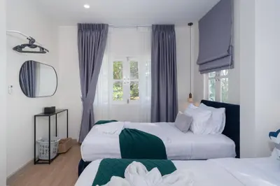 a bedroom with two beds and a window at Heart Patong pool villa with 5bedrooms in Patong Beach