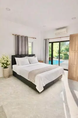 a bedroom with a large bed and a large window at Phuket Villa - Private Pool in Ban Kathu