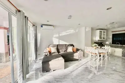 a living room with a couch and a table at Phuket Villa - Private Pool in Ban Kathu