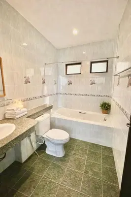 a bathroom with a toilet and a tub and a sink at Phuket Villa - Private Pool in Ban Kathu