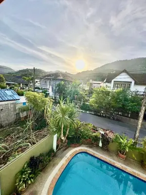a swimming pool on the side of a house at Phuket Villa - Private Pool in Ban Kathu
