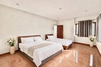 a hotel room with two beds and two windows at Phuket Villa - Private Pool in Ban Kathu
