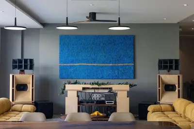 a living room with a fireplace and a blue painting at Lux Nine Pasak by MonthstayZ Thailand in Ban Pak Lak
