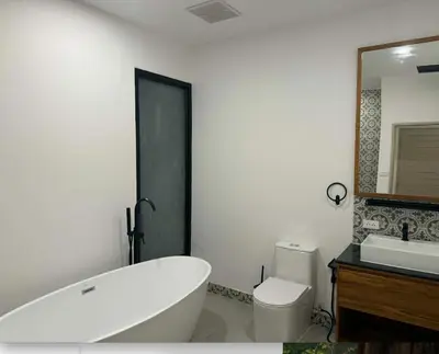 a bathroom with a tub and a toilet and a sink at Upstairs in Rawai Beach