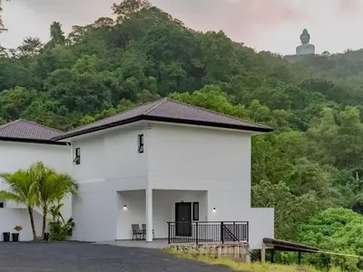 a white building with a mountain in the background at Brand New Private pool villa Chalong Phuket Mountain view in Ban Klang