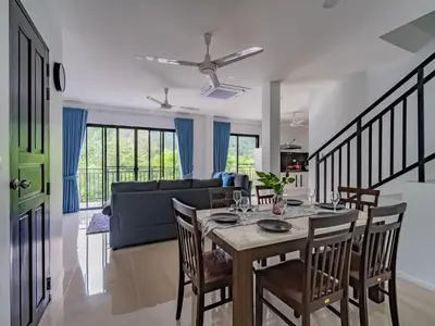 a dining room and living room with a table and chairs at Brand New Private pool villa Chalong Phuket Mountain view in Ban Klang