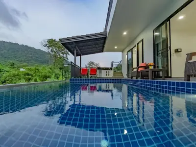 a swimming pool in a house with a villa at Brand New Private pool villa Chalong Phuket Mountain view in Ban Klang
