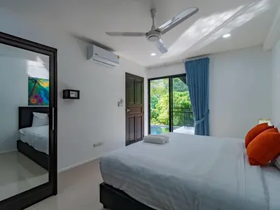 a bedroom with a bed and a mirror at Brand New Private pool villa Chalong Phuket Mountain view in Ban Klang