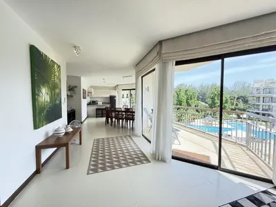 an open living room with a view of a pool at Dewa 1302 Poolside Resort Spacious 2 Bedroom in Phuket Town