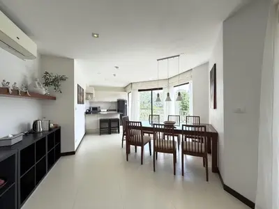 a kitchen and dining room with a table and chairs at Dewa 1302 Poolside Resort Spacious 2 Bedroom in Phuket Town
