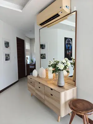 a mirror on a dresser in a living room at Dewa 1302 Poolside Resort Spacious 2 Bedroom in Phuket Town