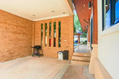 a brick wall with windows on the side of a house at 2 bedroom pool villa 250m TO Rawai beach A5 in Rawai Beach