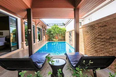 a swimming pool in a house with two chairs at 2 bedroom pool villa 250m TO Rawai beach A5 in Rawai Beach