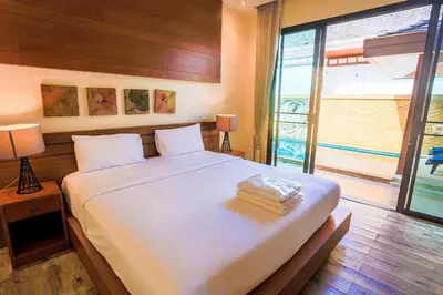 a bedroom with a large bed and a large window at 2 bedroom pool villa 250m TO Rawai beach A5 in Rawai Beach