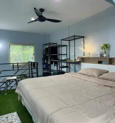 a bedroom with a bed and a ceiling fan at Spacious Garden Loft Home Studio Workation & Fit in Ban Na Nai